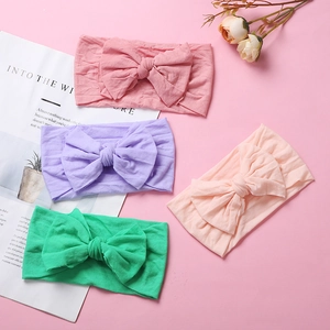Set of four soft nylon baby headbands with large double bows in pastel colors