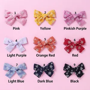Set of nine colorful cotton lace bow hair clips with delicate white floral embroidery