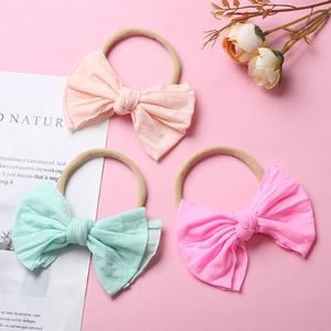 Lot de trois bandeaux bébé en nylon souple avec grands nœuds en couleurs pastel