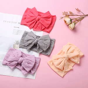Set of four soft nylon baby headbands with swallowtail bows in red, grey, and pastel colors