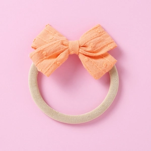 Orange jacquard bow headband for infants featuring soft nylon elastic baby hair band accessory