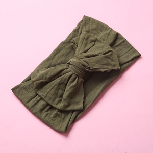 Detailed texture of army green soft nylon baby headband with double-layered knot bow