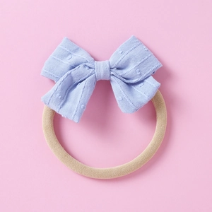 Detail of baby headband featuring light blue jacquard bow and elastic nylon band