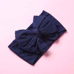 Detail of soft navy blue nylon wide headband with double-layered bow for babies and infants