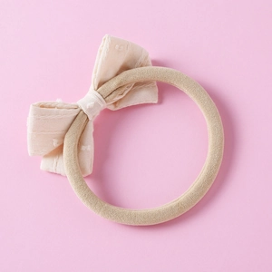 Close-up of soft jacquard bow headband for infants with high-elastic nylon seamless band