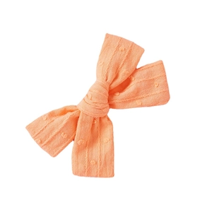 Pink cotton bow hair clip with jacquard dot pattern for girls on white background