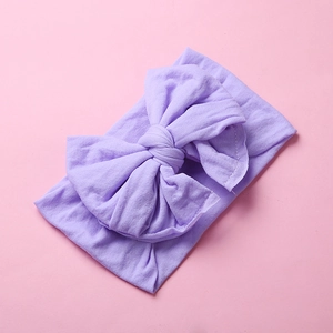 Macro shot of soft lavender nylon headband featuring a large double-layered bow for babies
