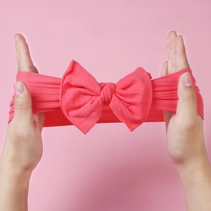 Close-up showing the high elasticity and soft knit texture of the nylon baby bow headband