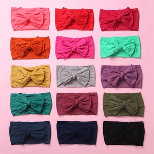 Detailed grid view showing 15 different colors of soft nylon baby bow headbands for infants