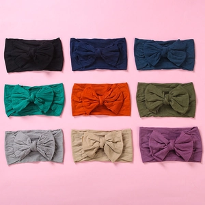 Detailed set of nine colorful soft nylon baby headbands with large bows for infants