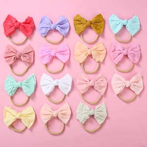 Détail du lot de 15 bandeaux bébé en nylon souple avec nœuds en coton de diverses couleurs