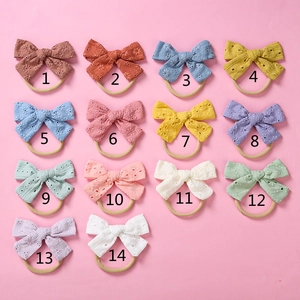 Macro view of cotton lace baby bow headbands in fourteen different soft colors