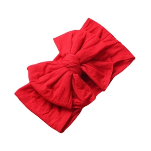 Soft red nylon wide headband with a large bow for baby girls and infants