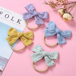 Soft nylon baby headbands set with four floral embroidered cotton bows in pastel colors