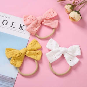 Soft nylon baby headbands with embroidered lace bows in pink, yellow and white colors