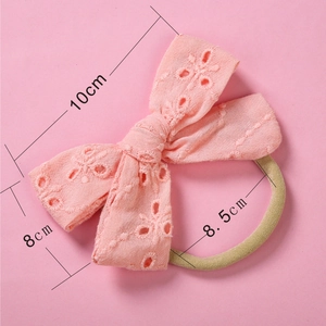 Close-up of pink lace embroidery bow with high elasticity nylon band for infants
