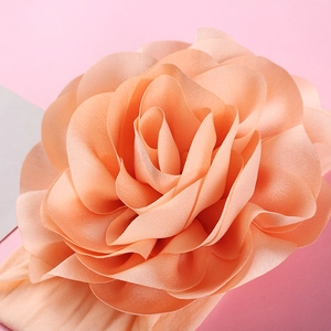 Large 3D floral nylon headband for babies featuring a soft coral pink fabric flower