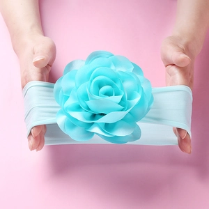 Close-up showing the high elasticity and soft texture of the blue nylon baby headband