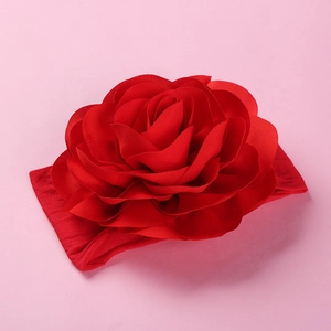 Detail of large red chiffon flower on a soft elastic nylon headband for babies