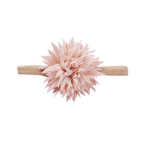 Close-up of a soft pink chiffon flower headpiece with a seamless nylon headband for infants
