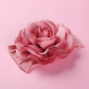 Detailed macro view of oversized 3D fabric rose on a soft nylon baby headband