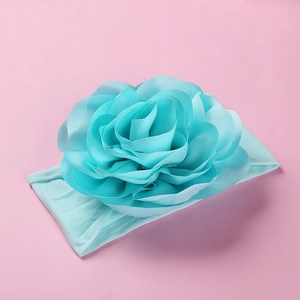 Detailed view of turquoise large chiffon flower on a soft elastic nylon baby headband