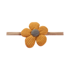 Detail of soft nylon baby headband featuring a knitted orange flower with grey center