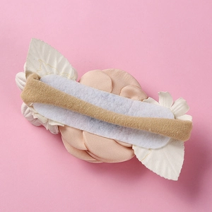 Detail view of the back of a floral baby headband with a high-elastic nude hair tie