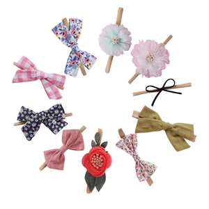 Detailed set of 10 soft nylon baby headbands with floral and fabric bow designs