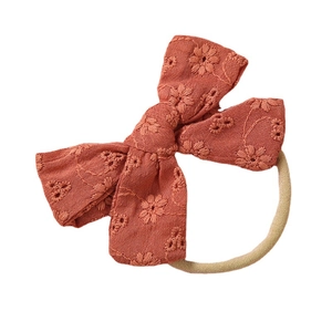 Cotton embroidered bow headband for babies with soft nylon band in burnt orange color