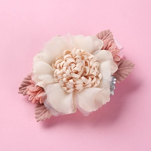 Detail of multi-layer tulle flower hair clip with pearls and pink fabric leaves