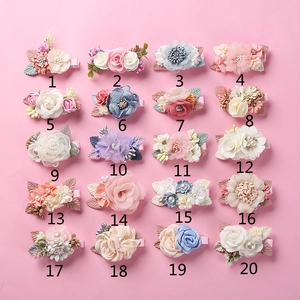 Detail view of 20 assorted fabric flower hair clips with pearls and lace for girls