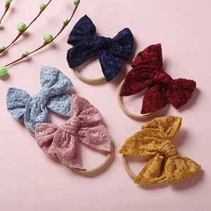 Detailed set of five lace bow headbands in various colors for infants and girls