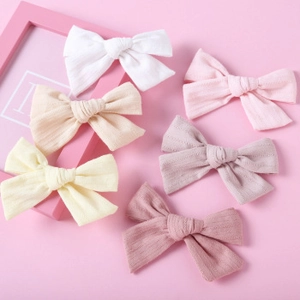 Detailed set of six colorful knitted bow hair clips for girls with soft vertical rib texture