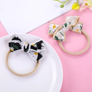 Floral embroidered daisy bow headbands in black and cream white for children