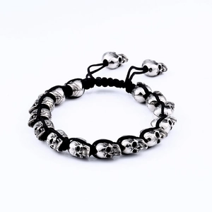 Men's punk skull bracelet in stainless steel with black braided cord and silver metal beads