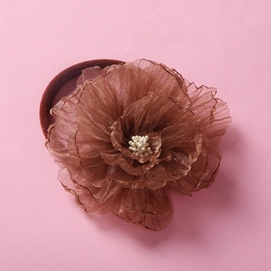 Detailed view of handmade layered brown chiffon flower on soft nylon elastic headband