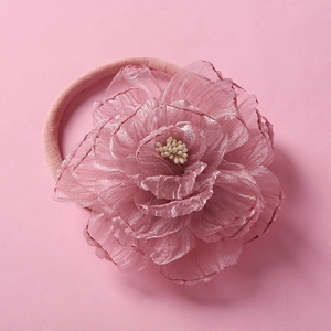 Detail of soft pink chiffon flower headband with delicate layered petals and nylon band