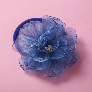 Detailed close-up of a blue chiffon flower headband with soft nylon elastic band