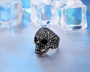 Macro shot of vintage skull ring with sugar skull carvings on a cool ice background