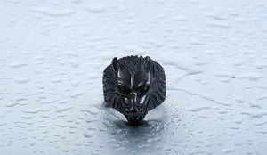 Close-up of a rugged black wolf head ring showing detailed metal carving and fur texture
