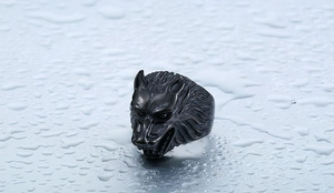 Detailed close-up of a vintage wolf head ring with black electroplated steel texture