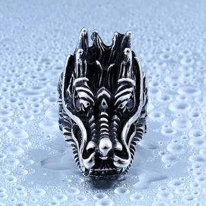 Close-up of a carved dragon head ring in vintage steel with red crystal eyes