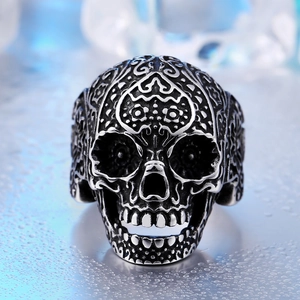 Vintage stainless steel skull ring with intricate floral vine engravings and oxidized finish