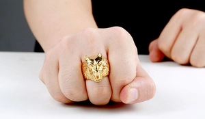 Detailed close-up of a men's vintage golden wolf head ring with realistic embossed texture