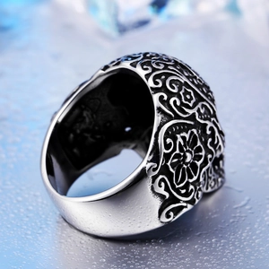Gothic skull ring for men in vintage stainless steel with floral engraving on cold background