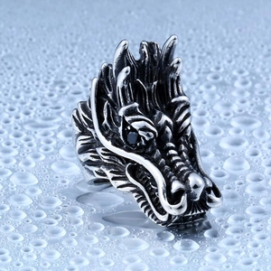 Macro detail of the dragon head ring showing fine metal scales and black gemstone eyes