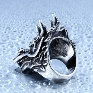 Detailed side view of a vintage silver dragon ring with intricate scales and horns
