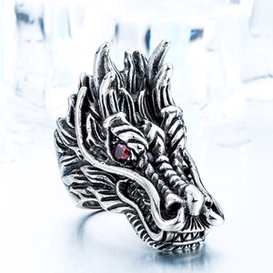 Detailed macro view of retro silver dragon ring featuring a vivid red gemstone eye