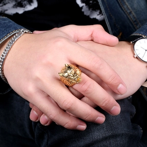 Men's vintage golden stainless steel wolf head ring shown worn on a hand in a casual setting